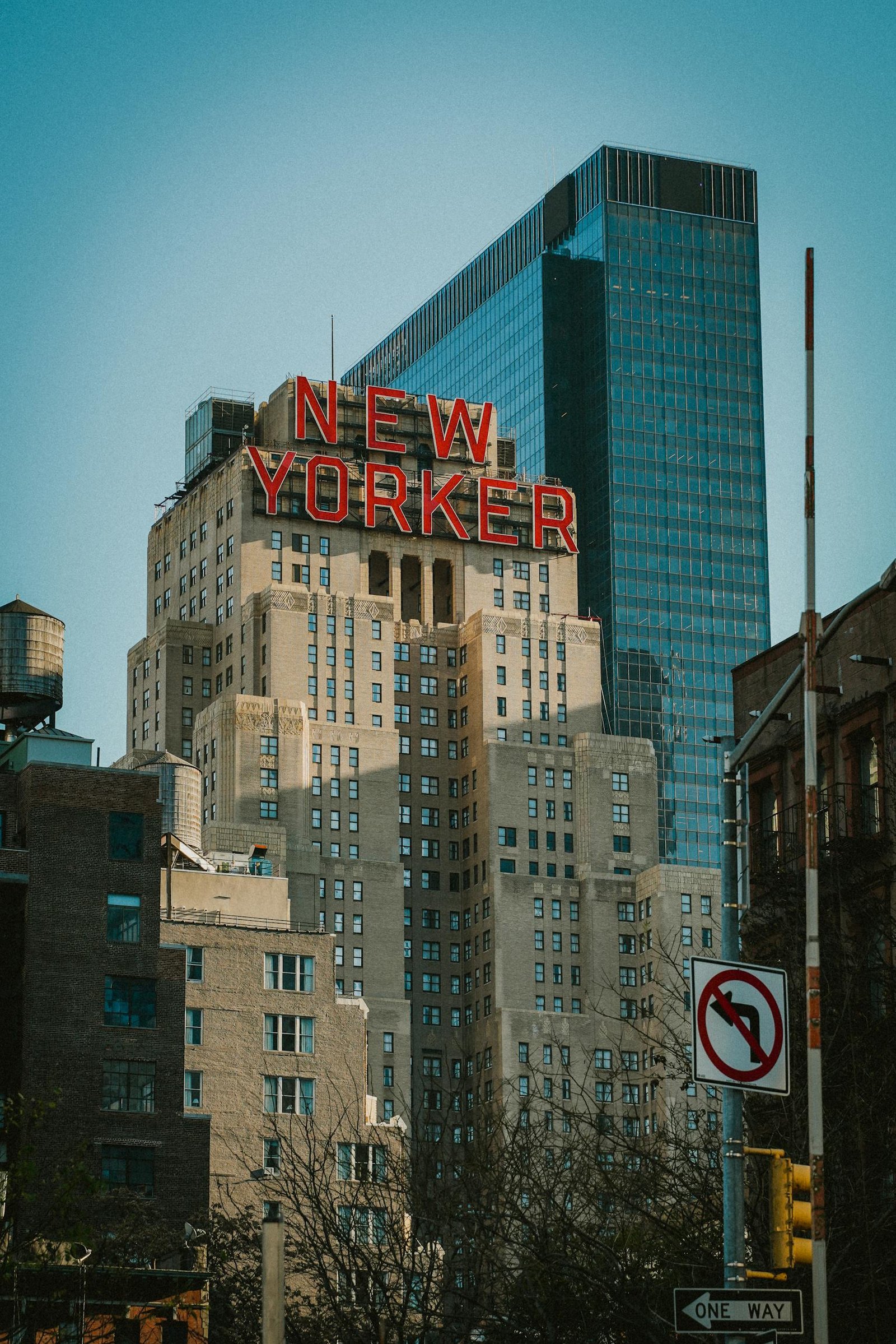 View of the historic New Yorker Hotel and surrounding skyscrapers in New York City.